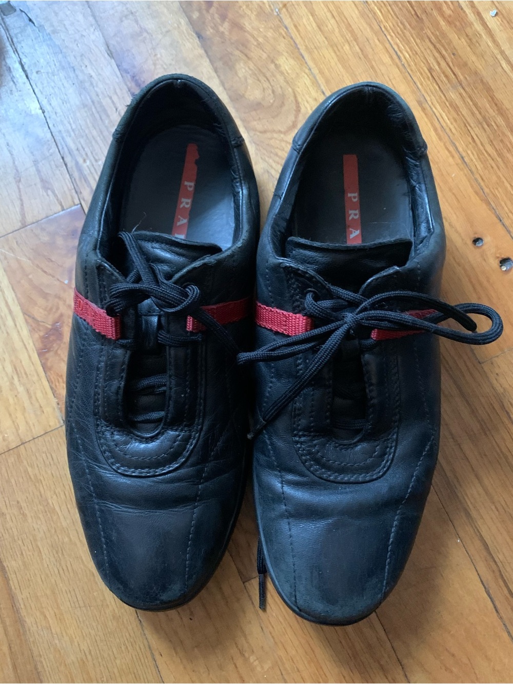 Prada Black Leather Sneakers with Red Stripe